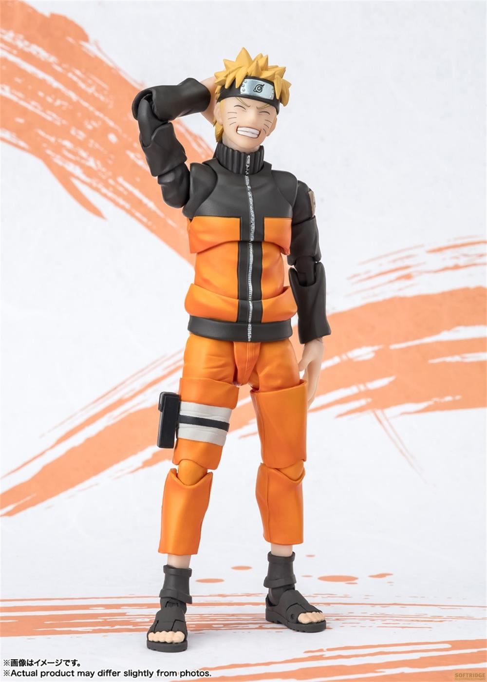 Action figure di Naruto in abiti arancioni e neri si gratta la testa.