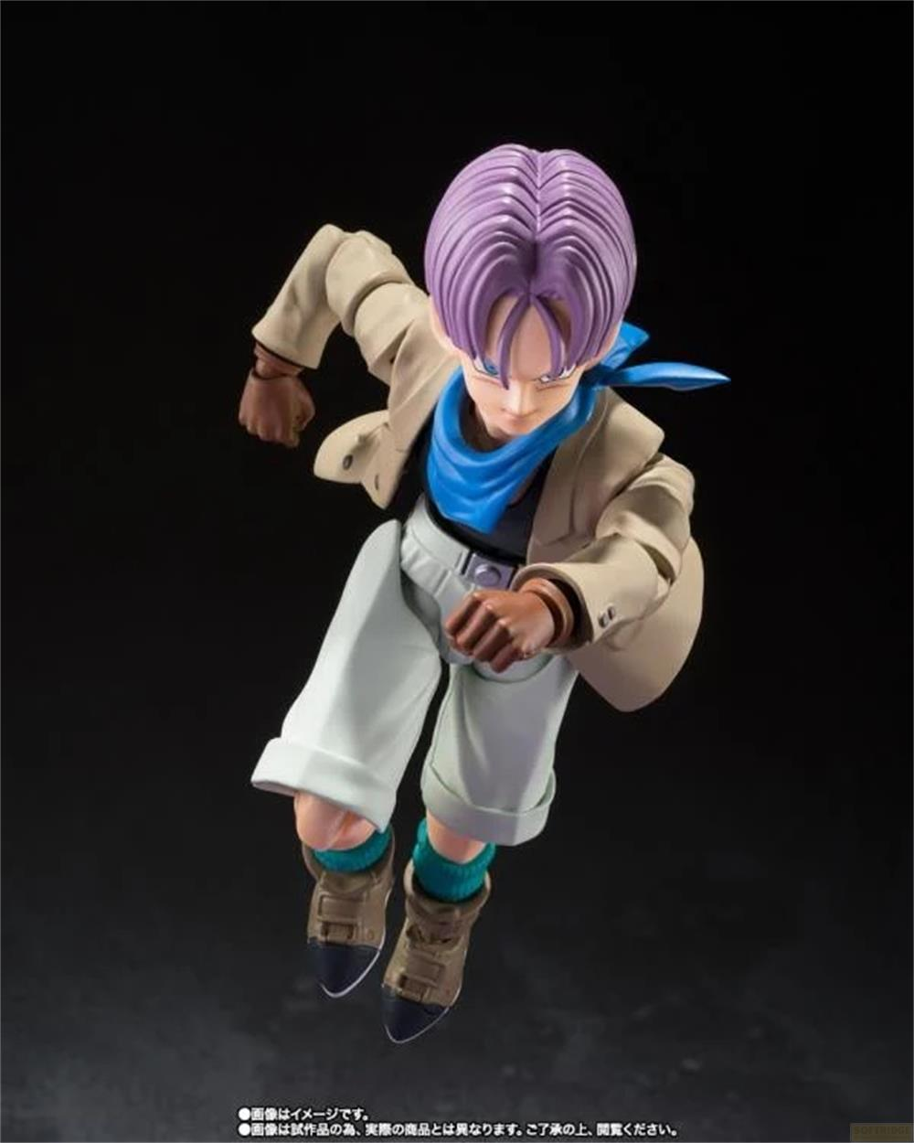 Eine Actionfigur mit lila Haaren, beiger Jacke, weißer Hose und blauem Schal.