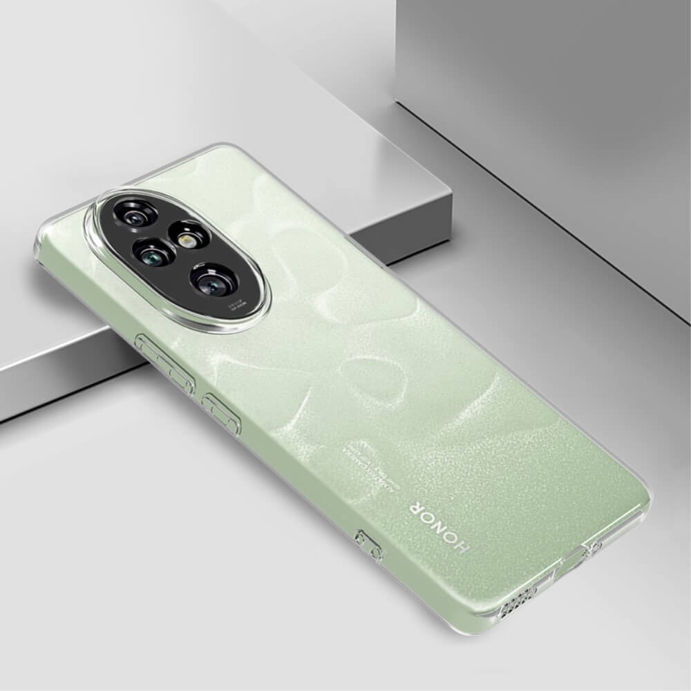 Un telefono verde chiaro con modulo fotocamera ovale poggia su una superficie grigia.
