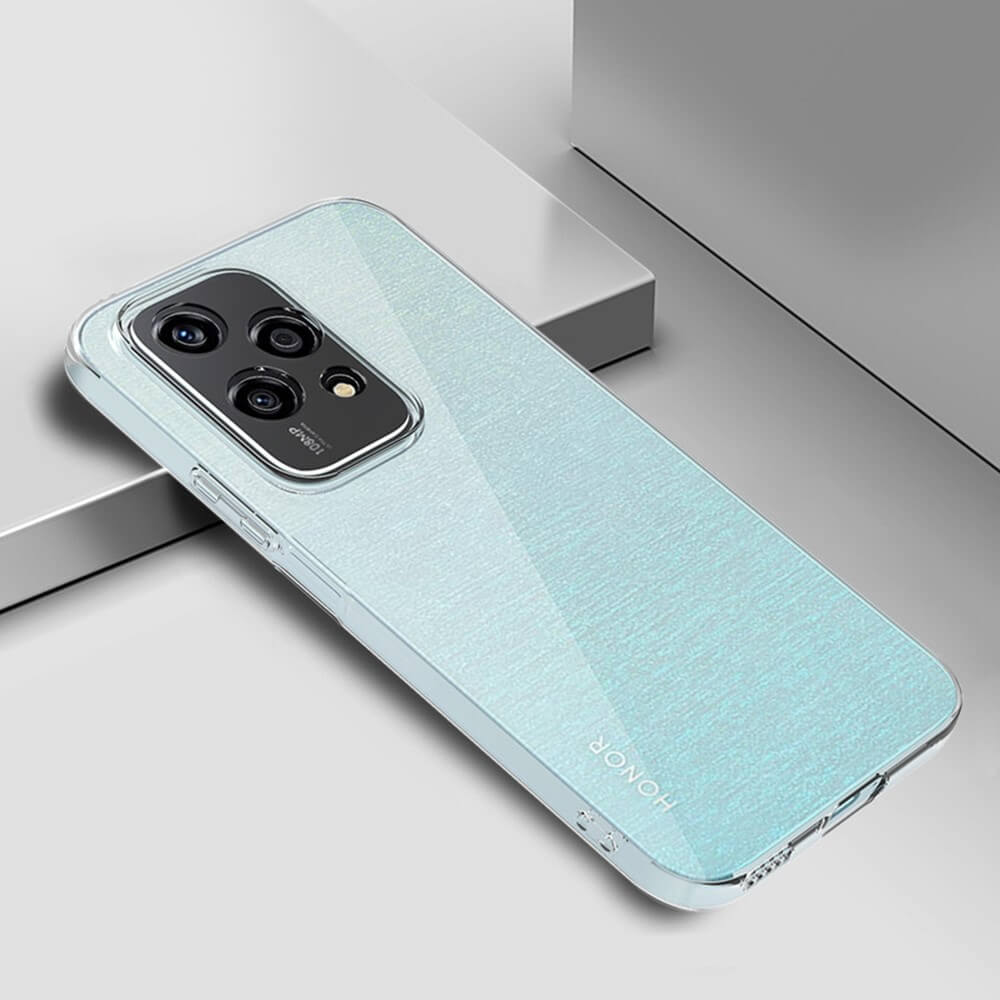 Un telefono azzurro con modulo fotocamera posteriore poggia su superficie grigia.
