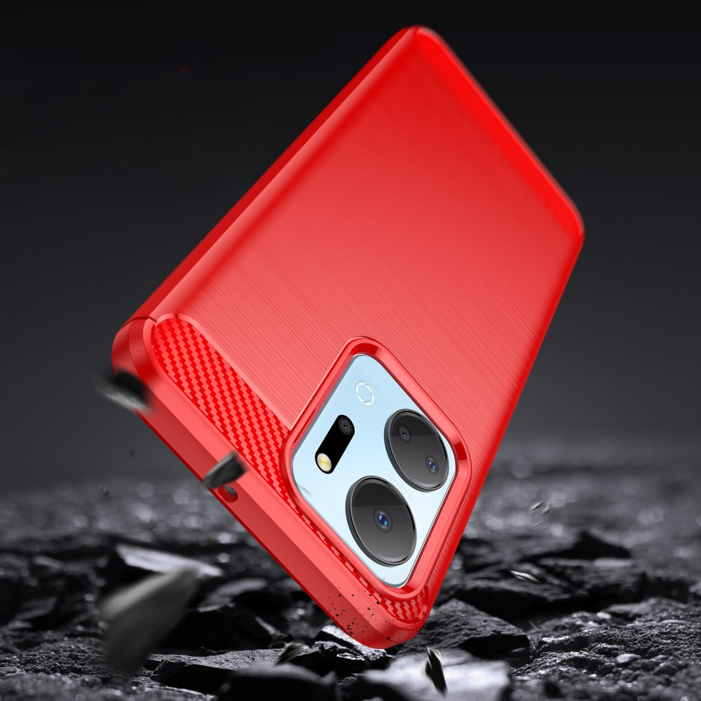 Une coque de téléphone rouge flotte au-dessus d'un sol brisé, montrant le module caméra.