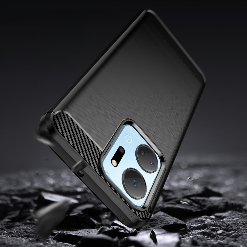 Téléphone noir avec accents carbone sur sol rocheux.