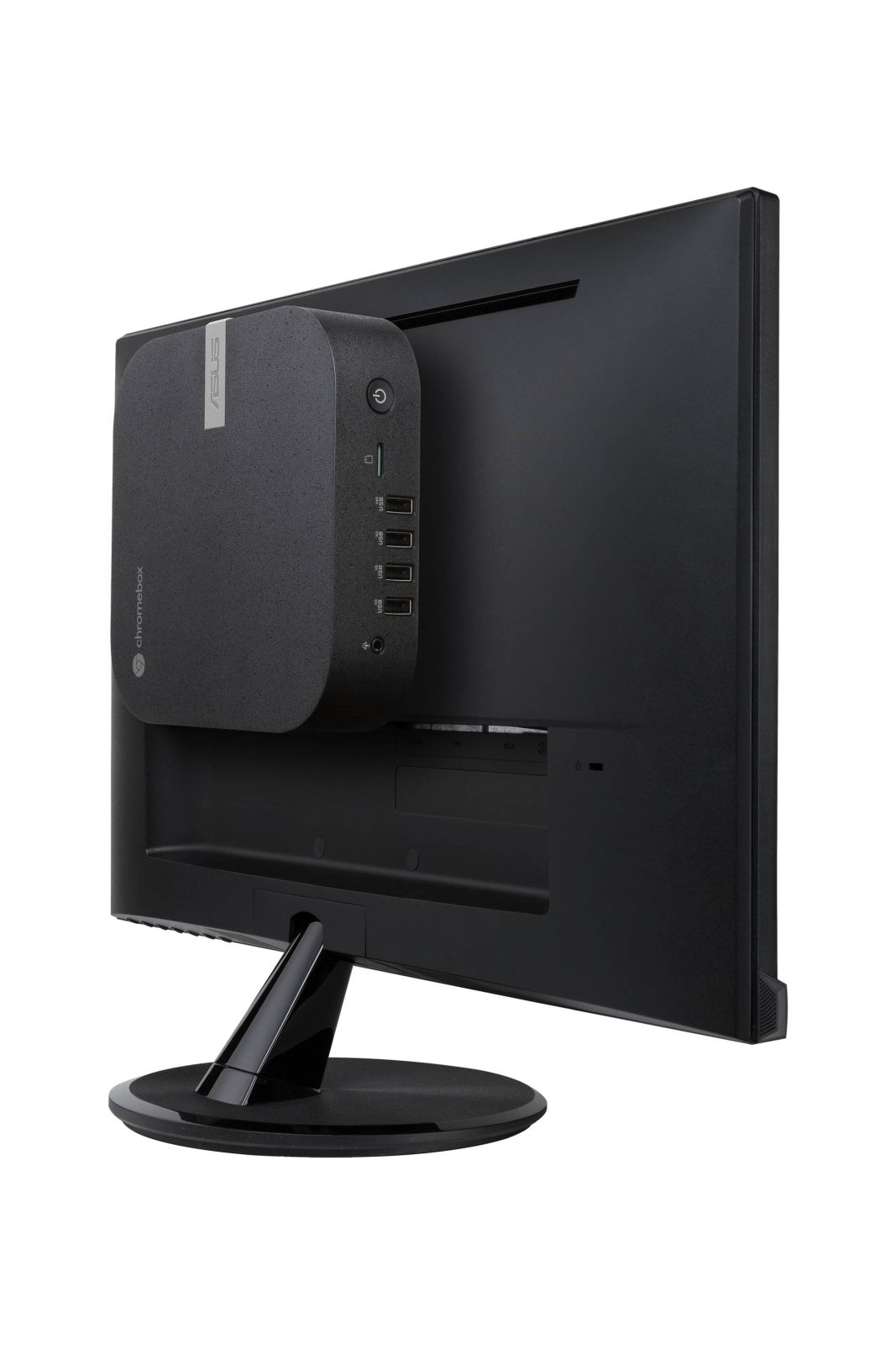 Un stick de computadora negro está sujeto a la parte posterior de un monitor.