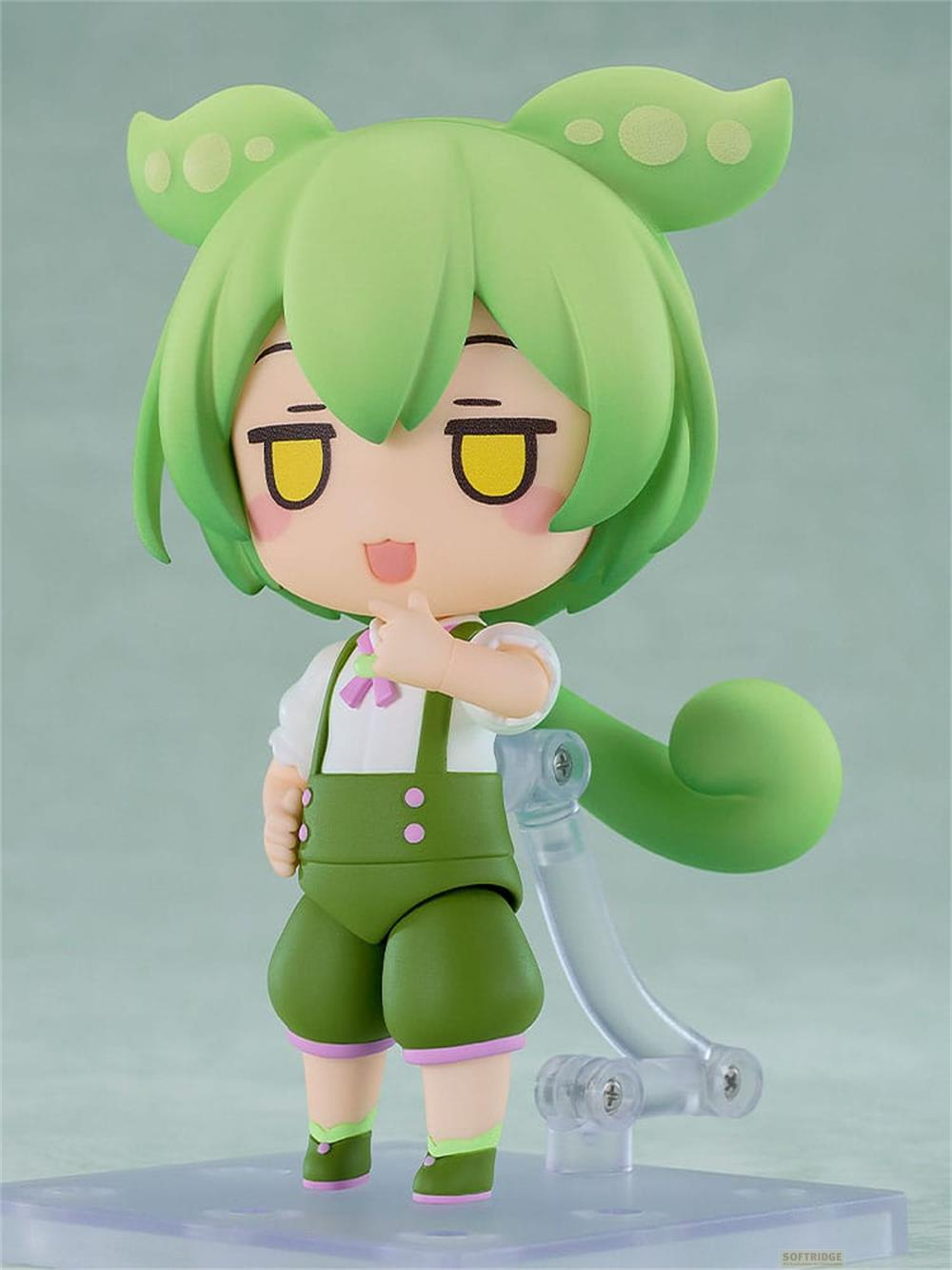 Grüne Anime-Figur mit großen Augen, die eine Latzhose trägt.