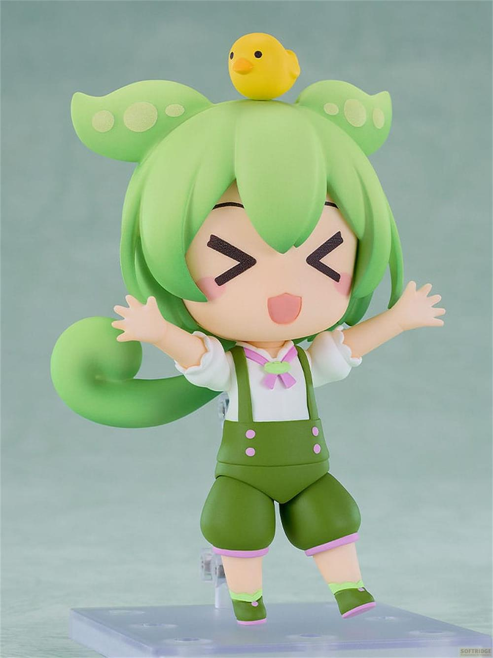 Eine grüne Figur mit einem kleinen gelben Küken auf dem Kopf.