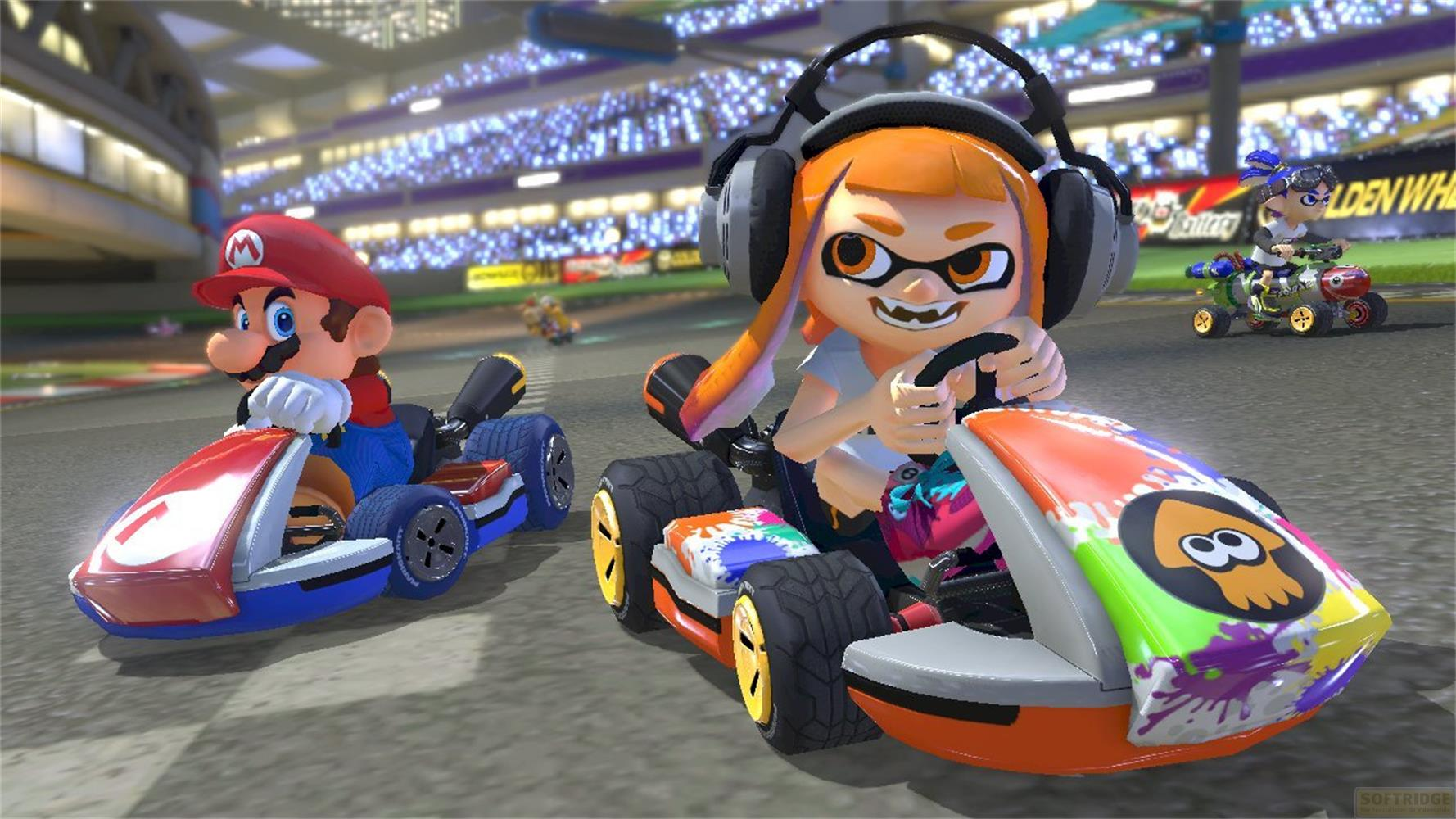 Mario e un Inkling gareggiano sui go-kart davanti a una folla.