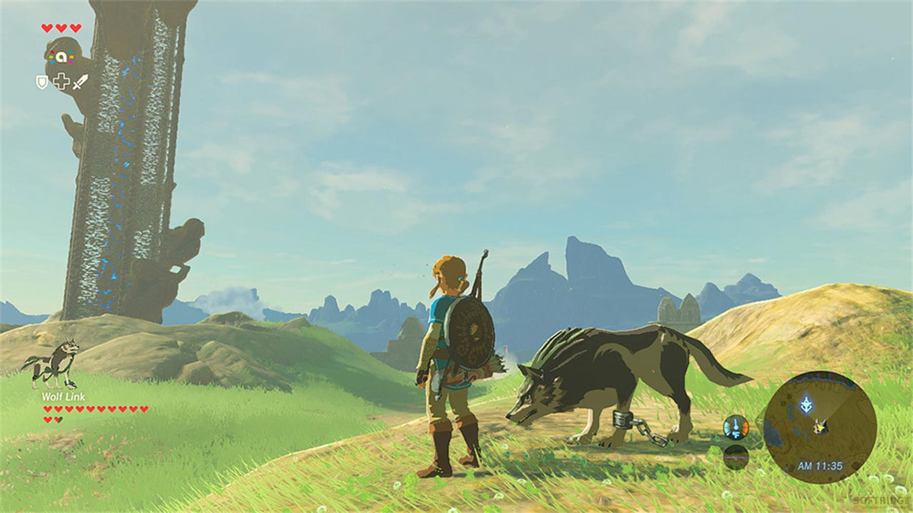 Link et un loup se tiennent dans un champ herbeux devant une tour et des montagnes.