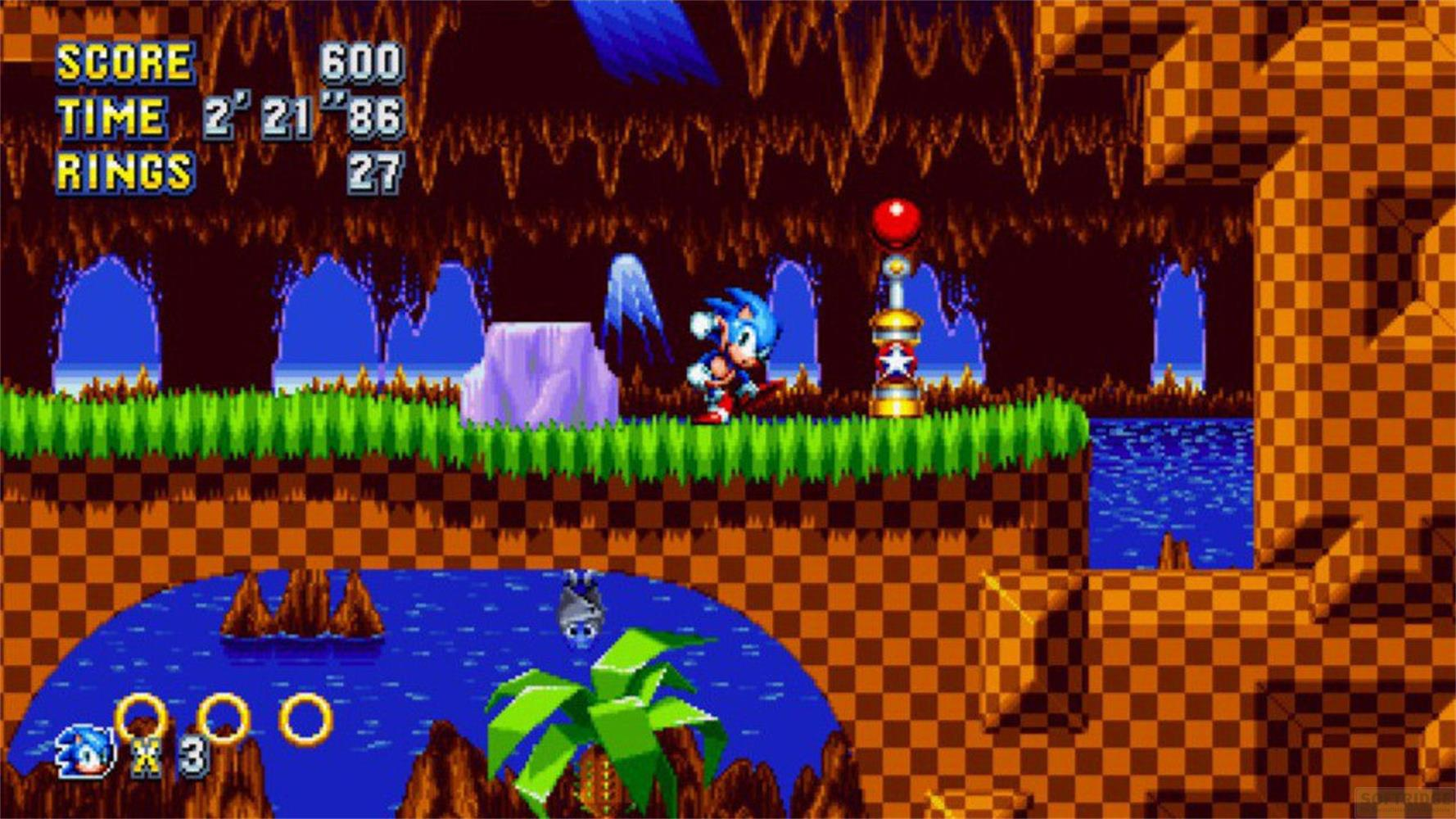 Sonic biegnie po zielonej platformie przed jaskiniową ścianą z niebieskimi stalaktytami.
