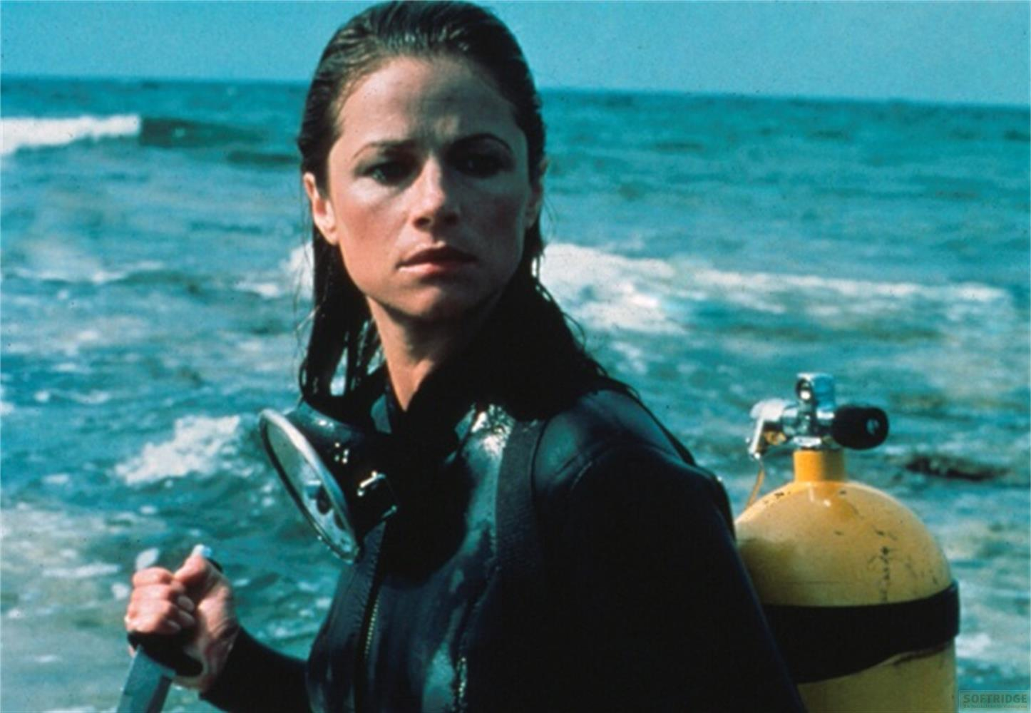 Eine Taucherin mit gelber Sauerstoffflasche und Maske im Meer.