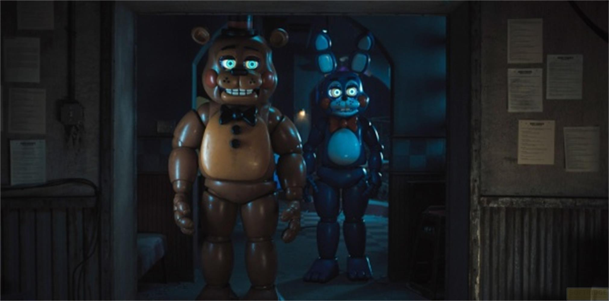 Un orso marrone e un coniglio blu con occhi luminosi in una stanza buia.