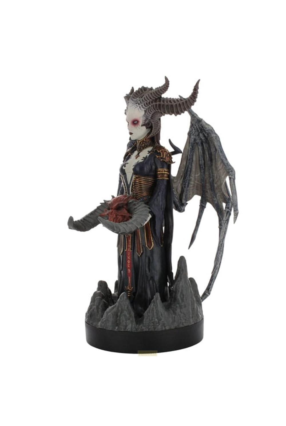 Figurine démoniaque avec cornes, ailes et tenant un cœur.
