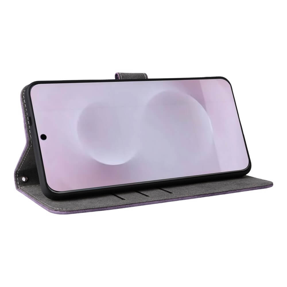 Uno smartphone in una custodia a libro viola, in piedi su una superficie bianca.