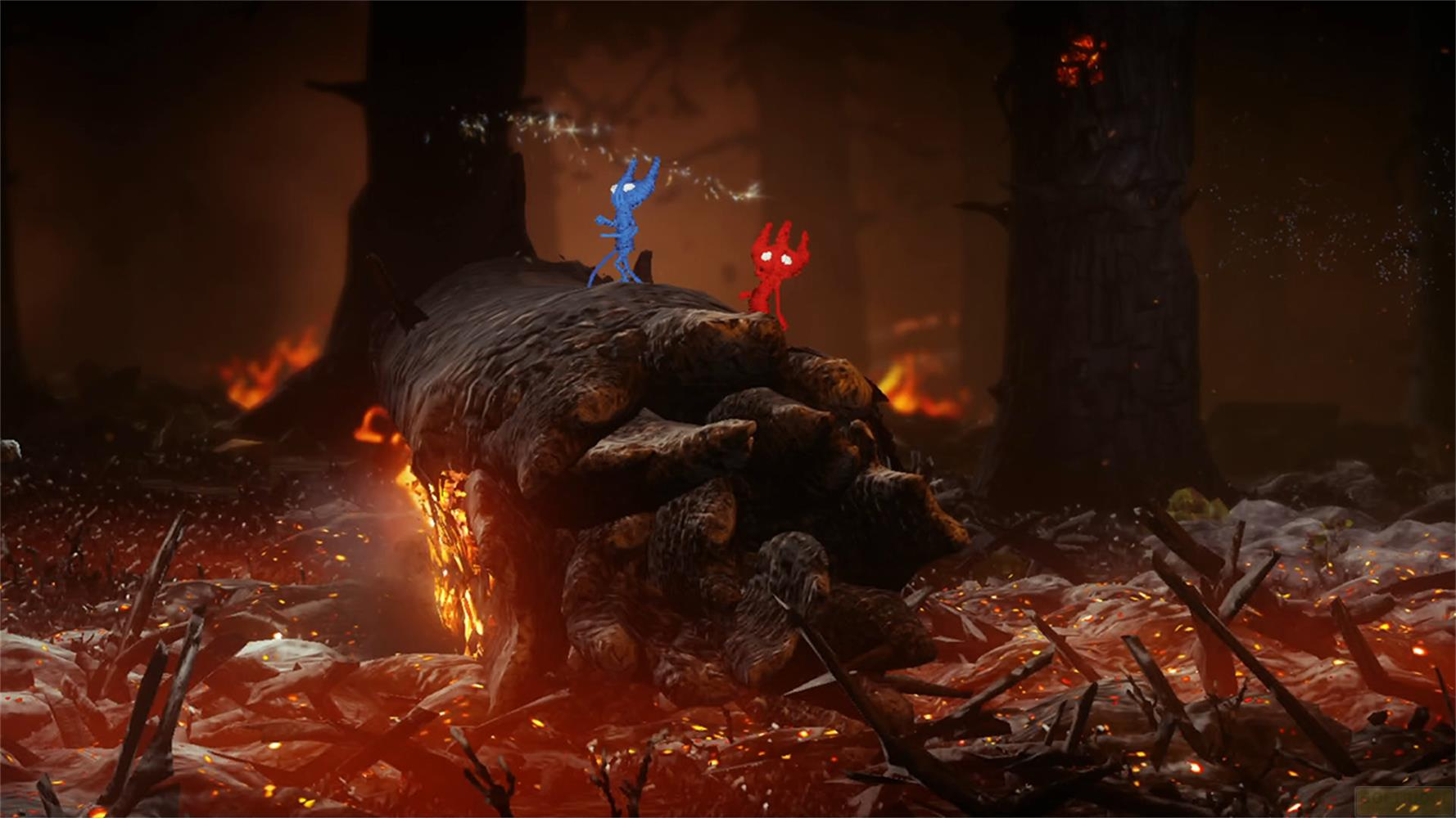 Un personnage bleu et un rouge se tiennent sur une bûche dans une forêt en feu.