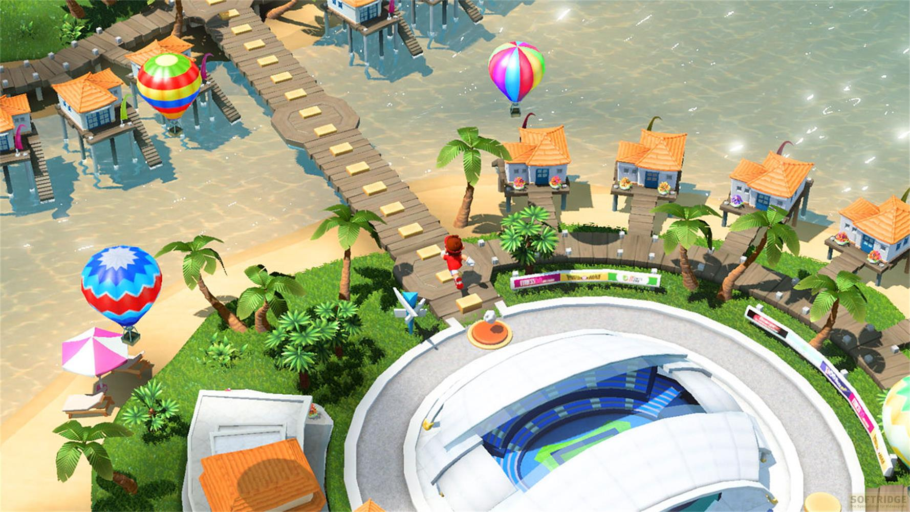 Palloncini colorati sopra una scena di spiaggia tropicale con case su palafitte.