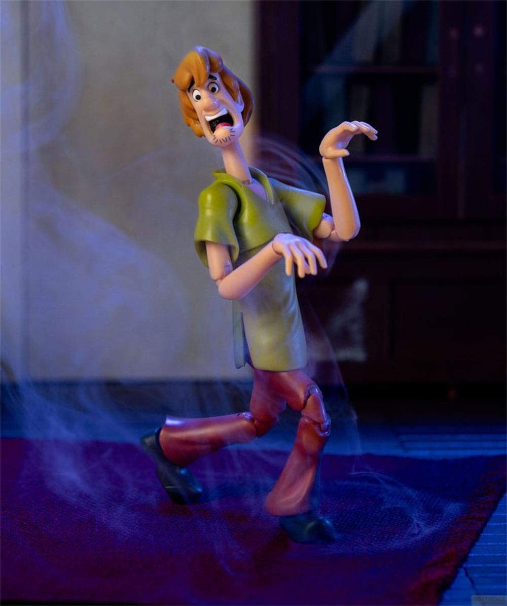 Una action figure di Shaggy con espressione spaventata, circondata da nebbia blu.
