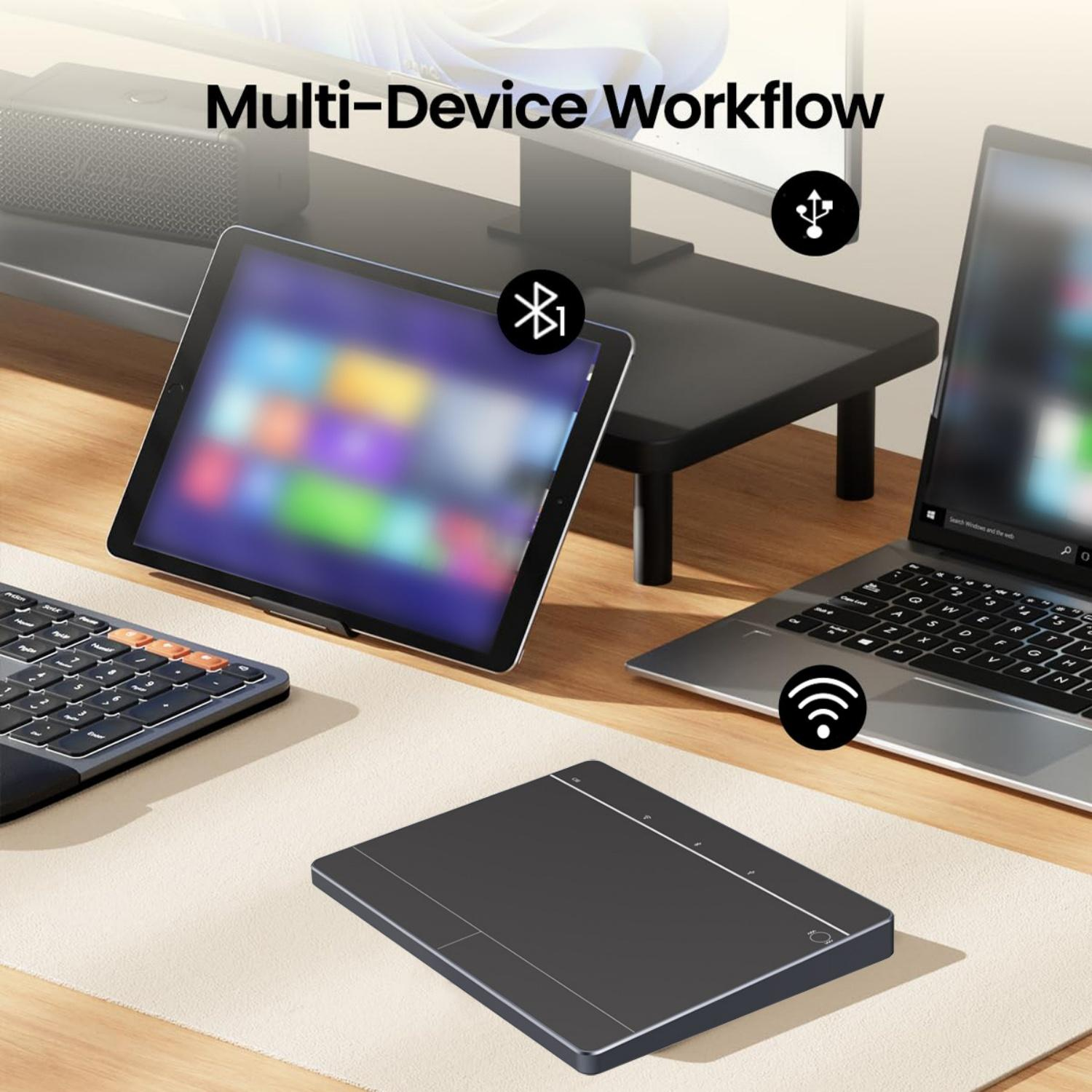 Ein Schreibtisch zeigt Laptop, Tablet, Tastatur und Trackpad für Multi-Device-Workflow.