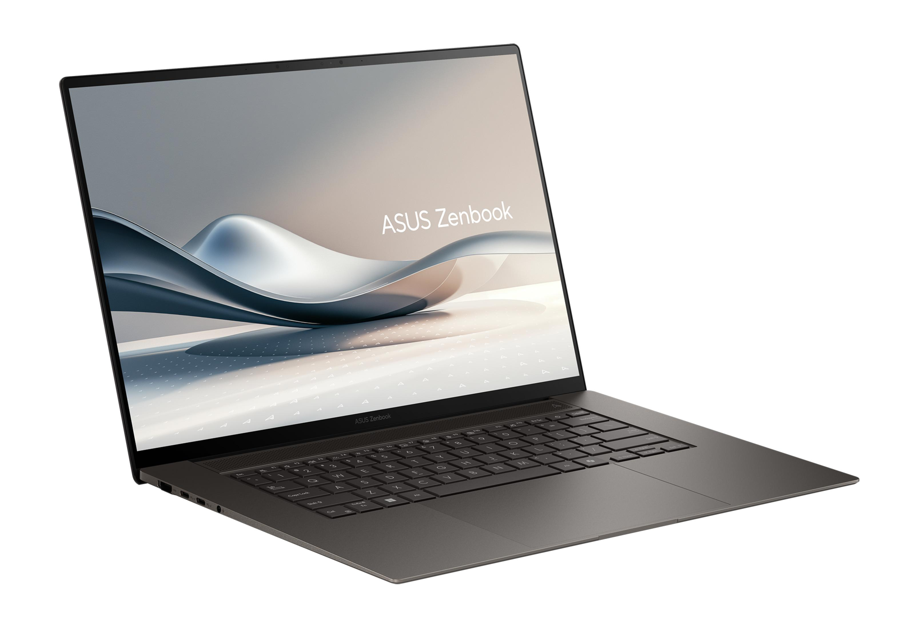 Ein graues Asus Zenbook Laptop mit beleuchteter Tastatur auf weißem Hintergrund.