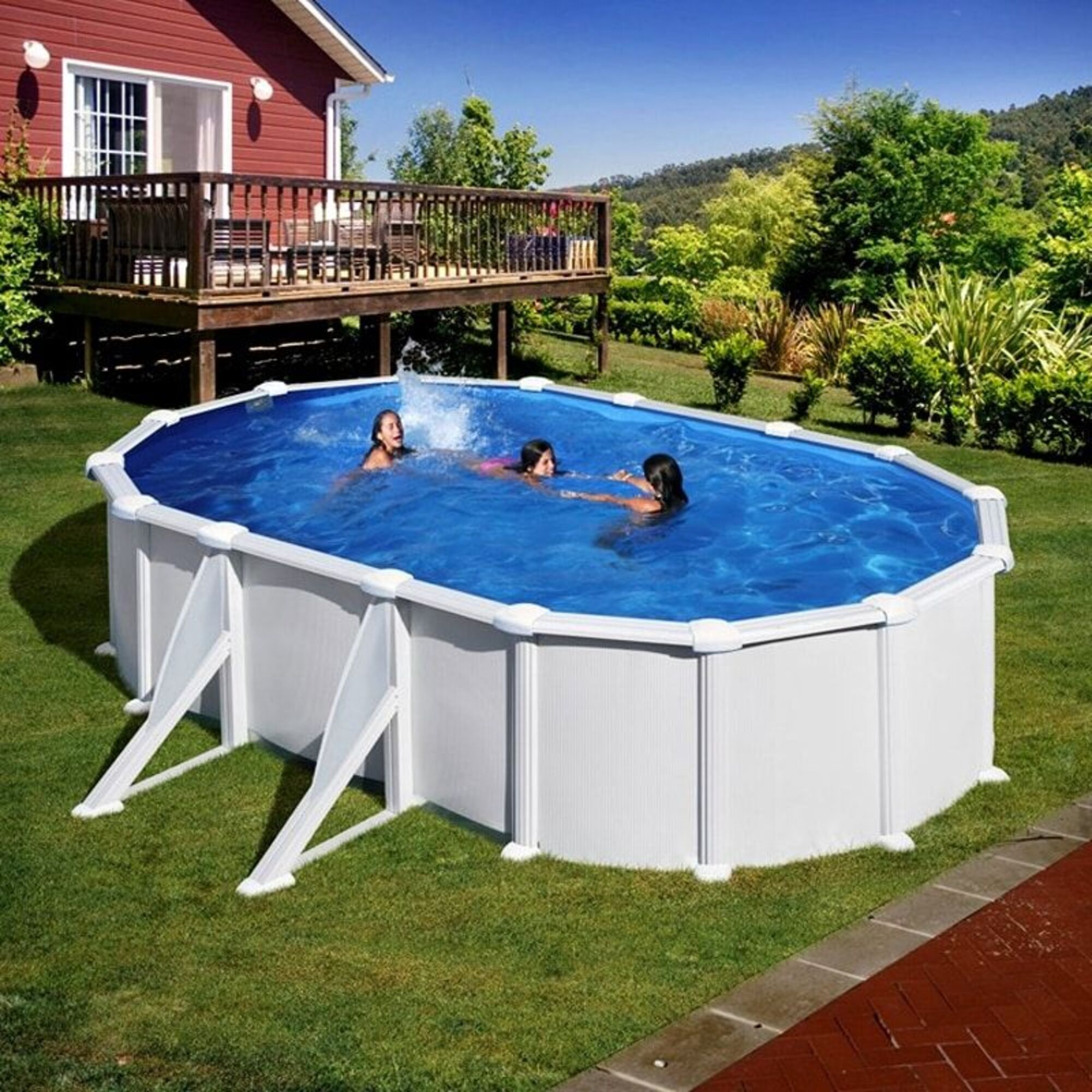 Tres chicas chapotean en una piscina ovalada elevada en un patio trasero.