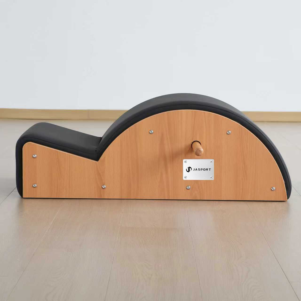 Un arco Pilates nero con lati in legno e logo JASPORT argentato.