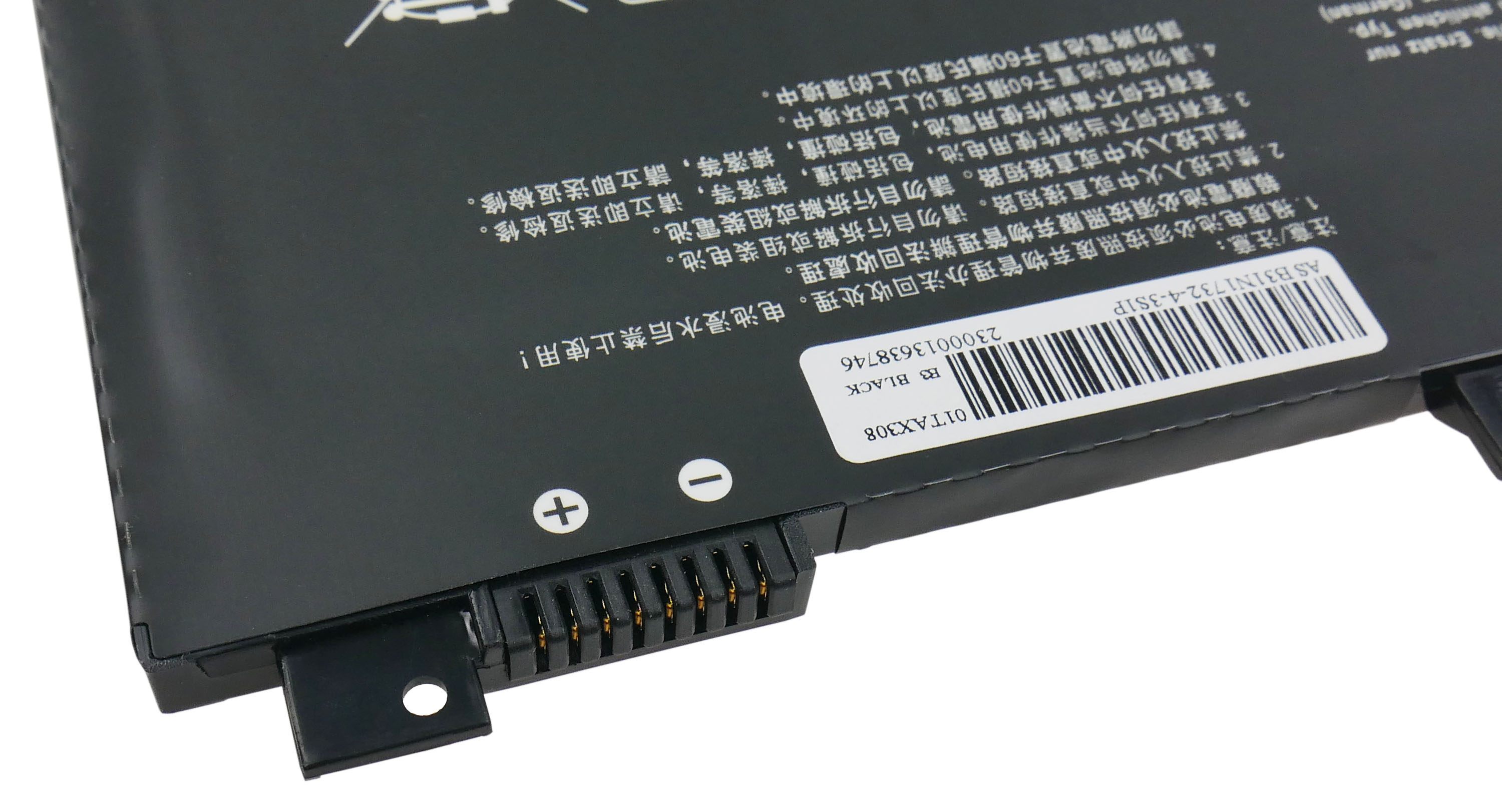 Czarna bateria do laptopa ze złączami i wielojęzycznymi ostrzeżeniami.