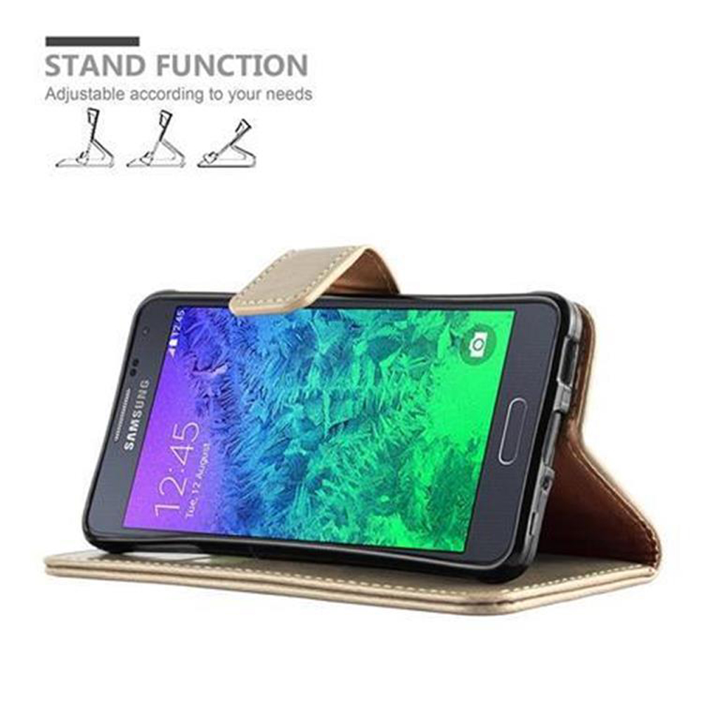 Ein goldener Handy-Ständer mit einem Samsung-Telefon, das auf dem Bildschirm steht.