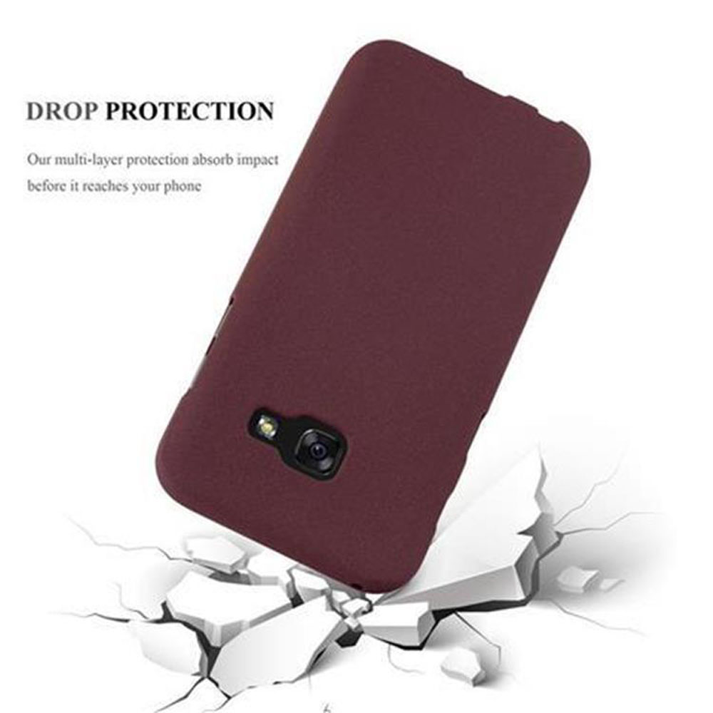 Custodia per telefono color vinaccia che rompe il terreno bianco. Testo: PROTEZIONE DA CADUTE.