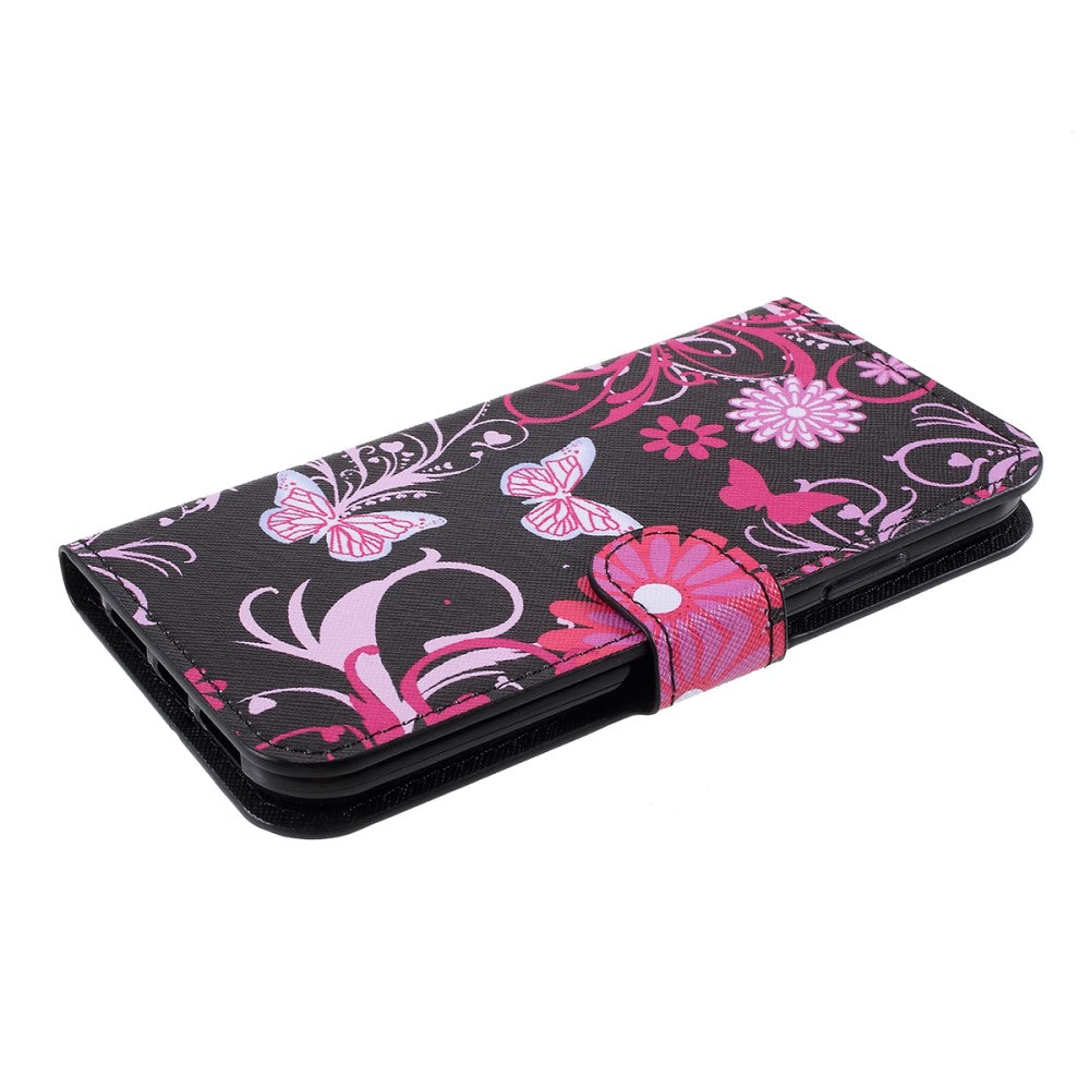 Custodia nera per telefono con farfalle rosa e motivi floreali.