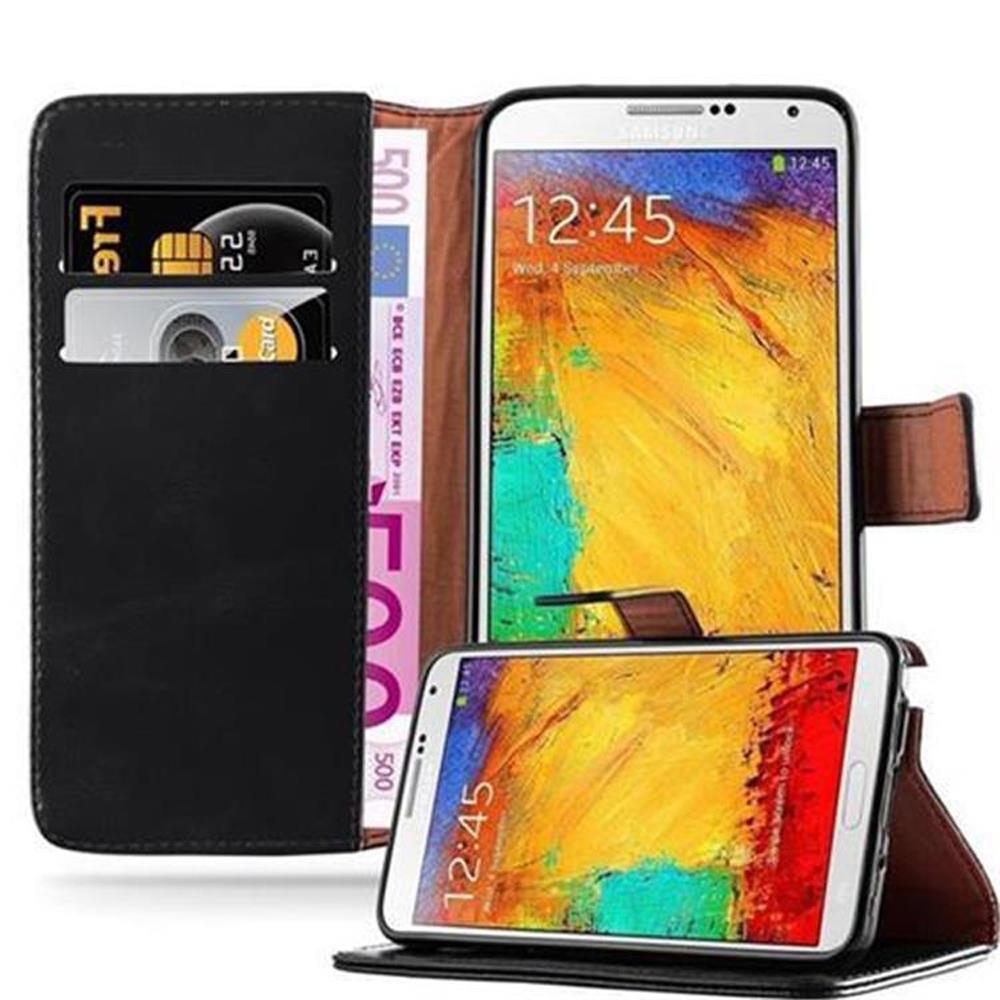 Cartera negra con billetes, tarjetas y dos teléfonos inteligentes.