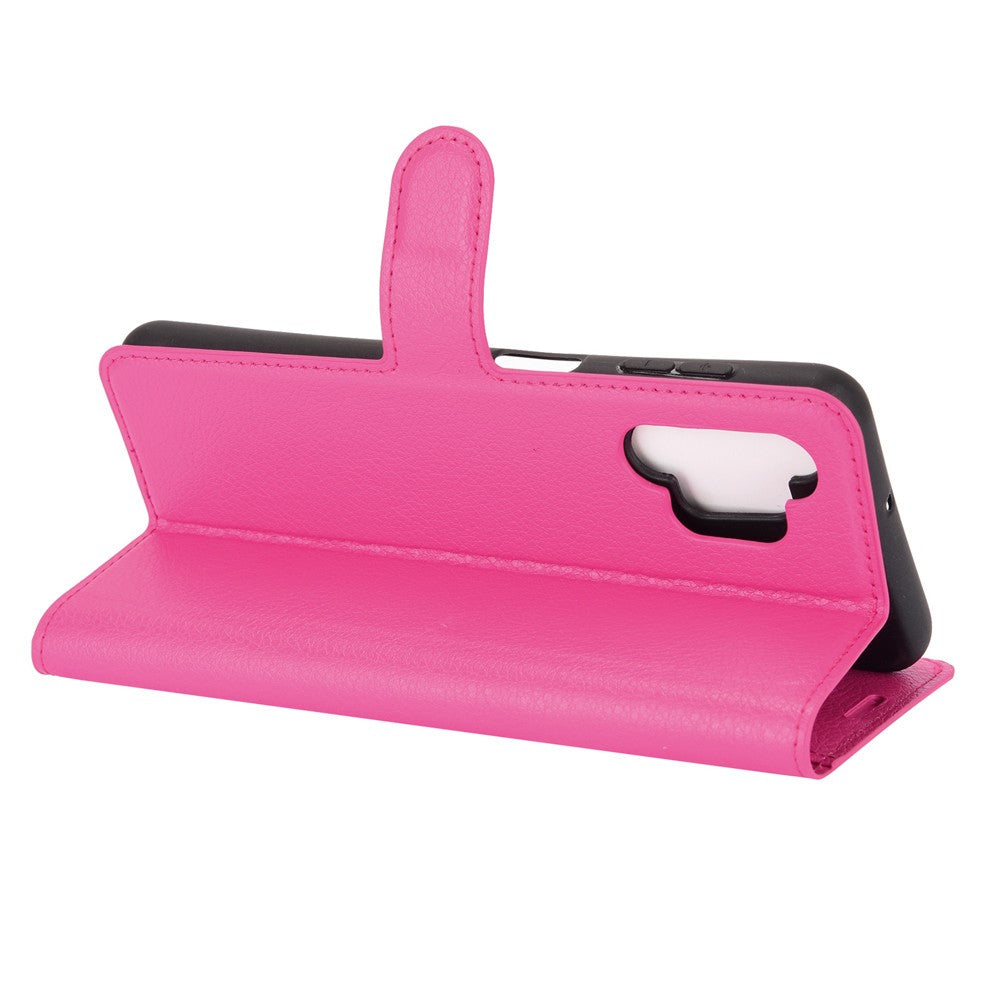 Una custodia a libro rosa aperta protegge uno smartphone.
