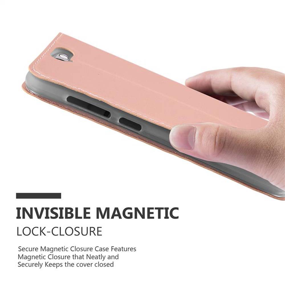Una mano tiene una custodia per telefono rosa con chiusura magnetica.
