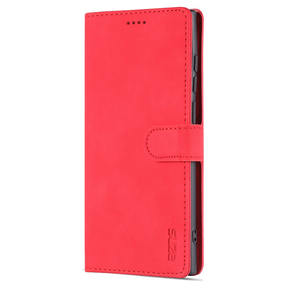 Custodia rossa a libro per telefono con linguetta e quattro puntini.