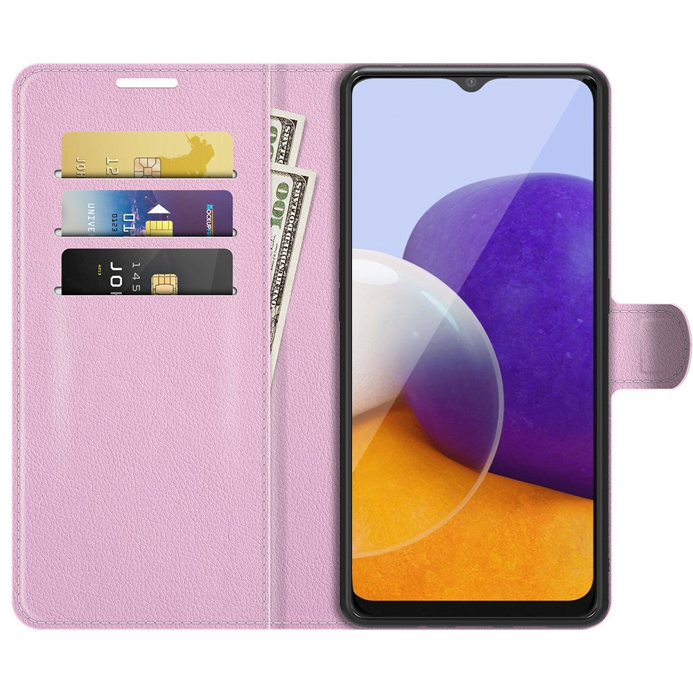 Portafoglio rosa per telefono con fessure per carte e banconote, accanto a uno smartphone.