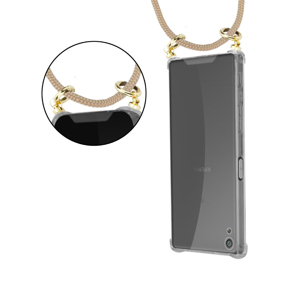 Ein Smartphone mit einem transparenten Gehäuse und einer beige Kordel.