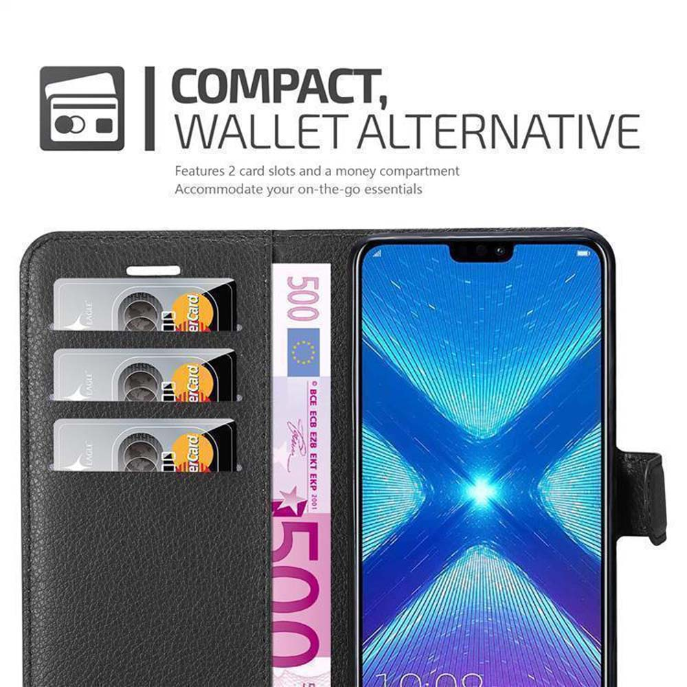 Portafoglio nero con slot per carte, banconota da 500 euro e smartphone.