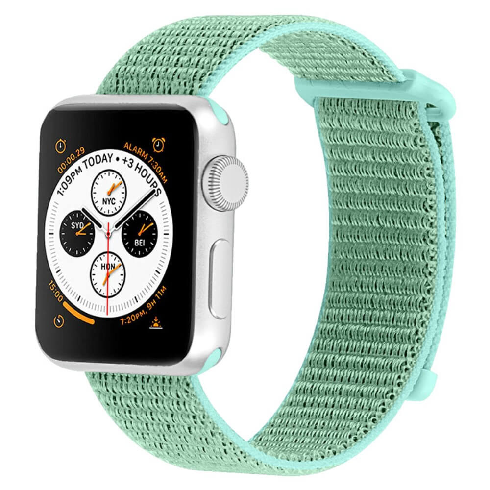 Montre connectée argentée avec bracelet en tissu sarcelle et cadran d'heure mondiale.