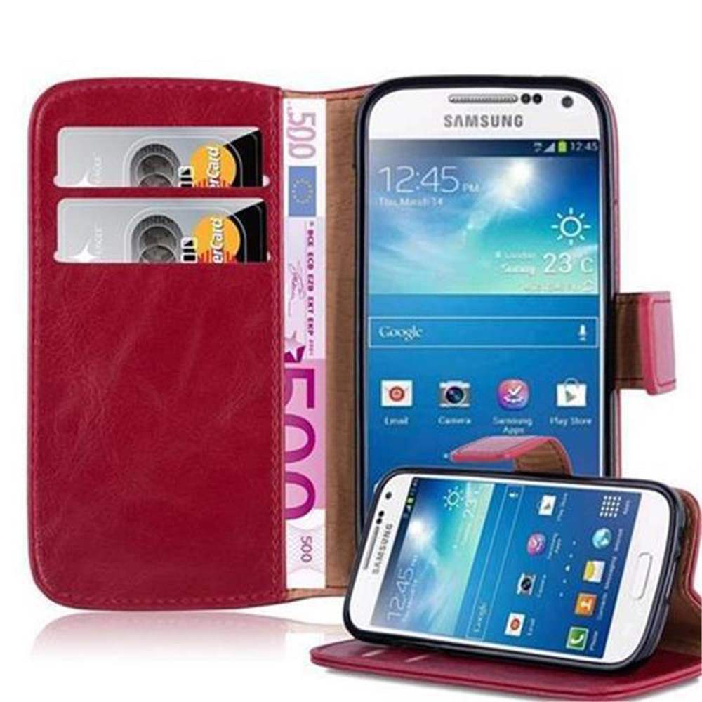 Funda de cuero roja con dos ranuras para tarjetas, un billete de 500 euros y dos teléfonos Samsung.