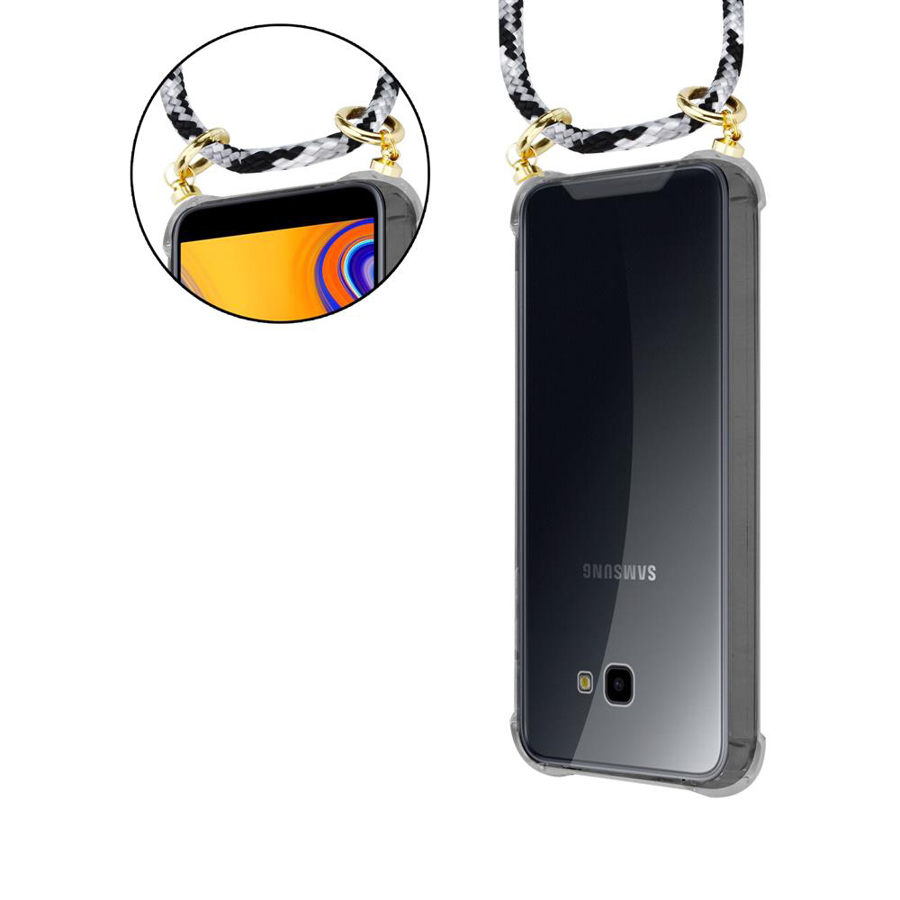 Un telefono Samsung nero in custodia trasparente con cinturino intrecciato.