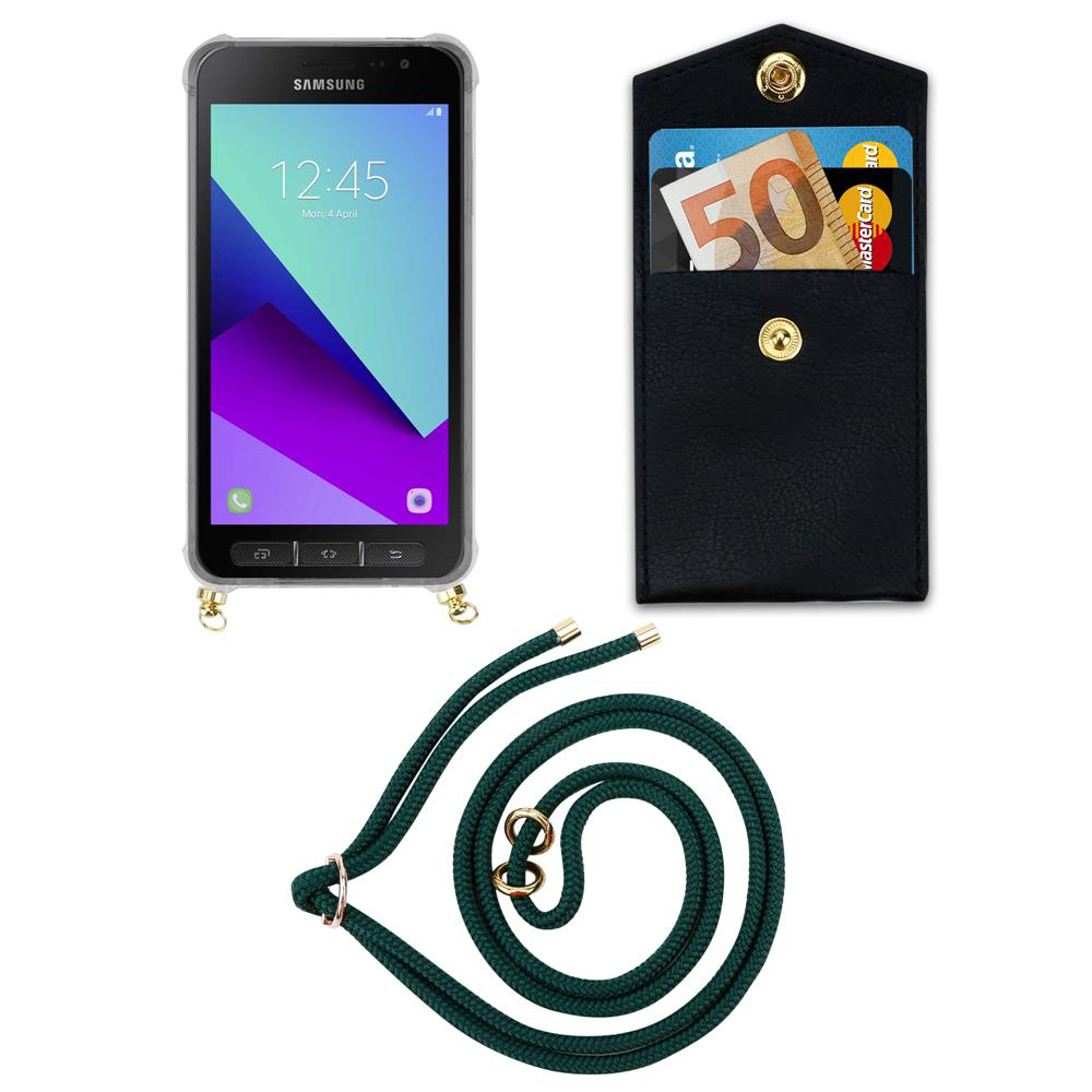 Uno smartphone Samsung in custodia trasparente, un portafoglio con banconote e carte e un cordino verde.