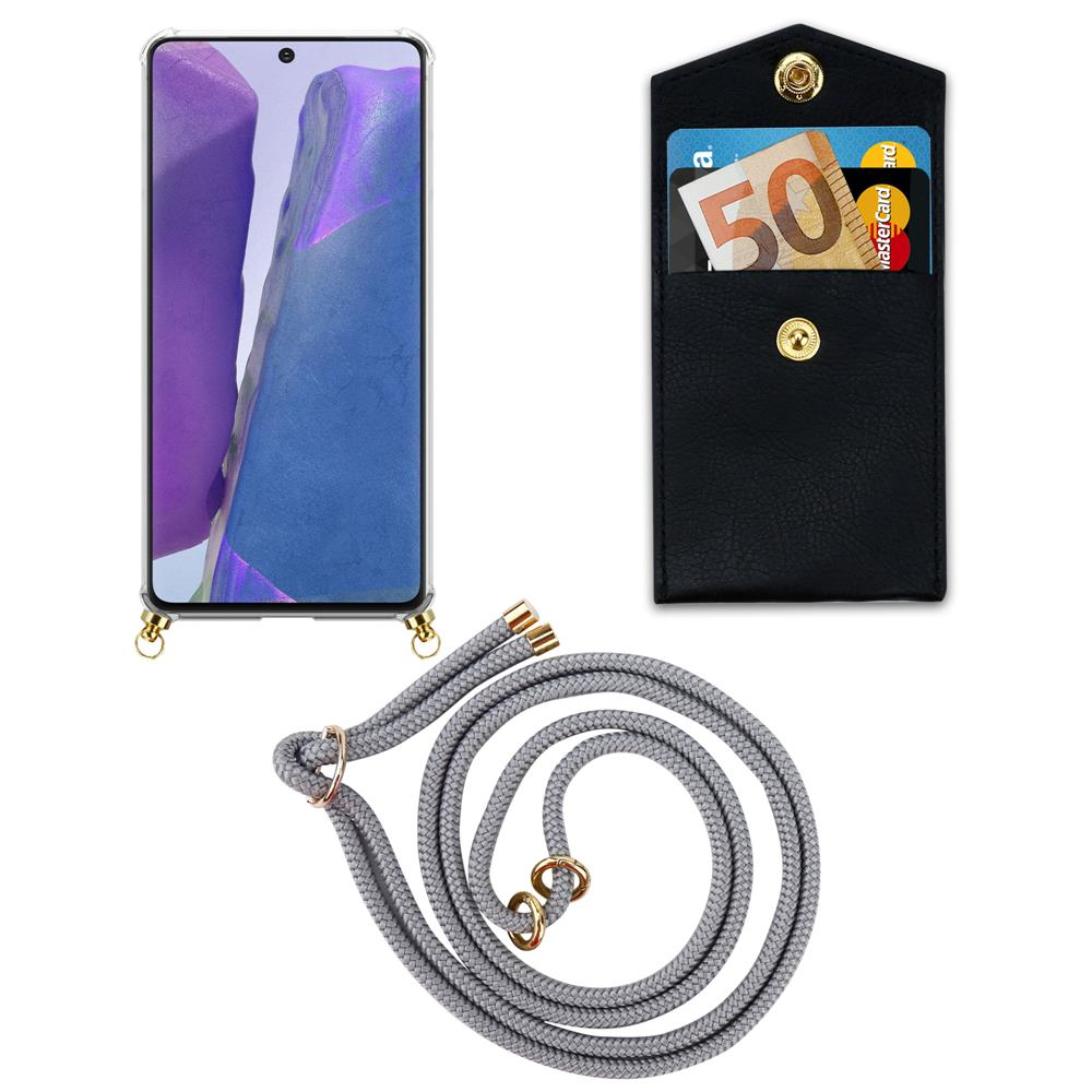 Uno smartphone in una custodia con un cordino e un portafoglio nero con soldi e carte.
