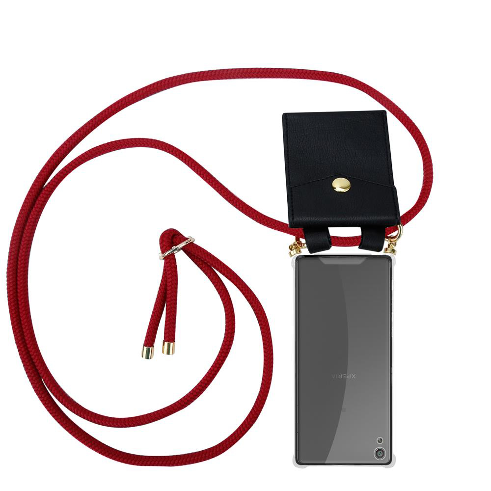 Schwarze Handytasche mit rotem Band und goldenen Akzenten.
