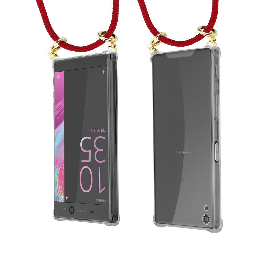 Zwei Smartphones in transparenten Hüllen, an roten Schnüren mit goldenen Ringen befestigt.