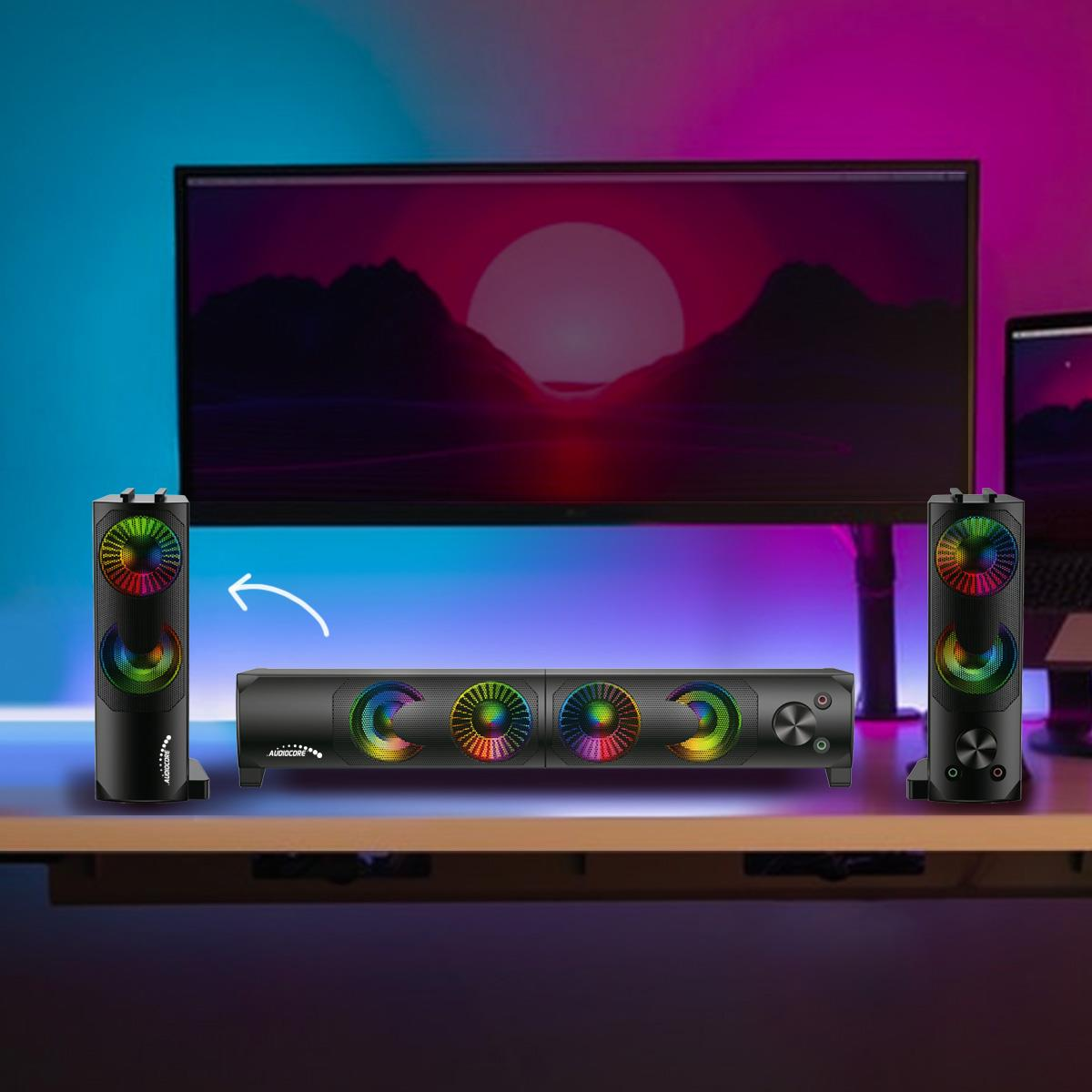 Un sistema de sonido con dos altavoces y una barra de sonido con iluminación RGB.