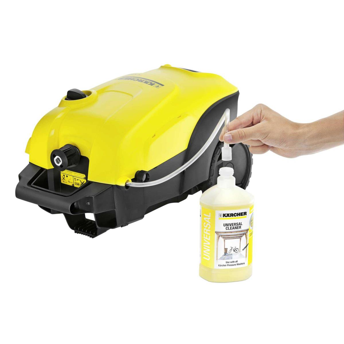 Yellow pressure washer with a hand inserting a cleaning agent bottle.
