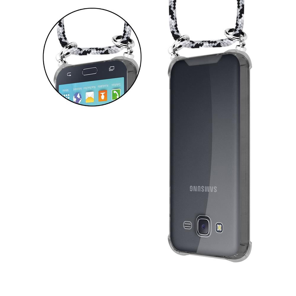 Ein durchsichtiges Samsung-Handy mit einem schwarz-weißen Band hängt vertikal.