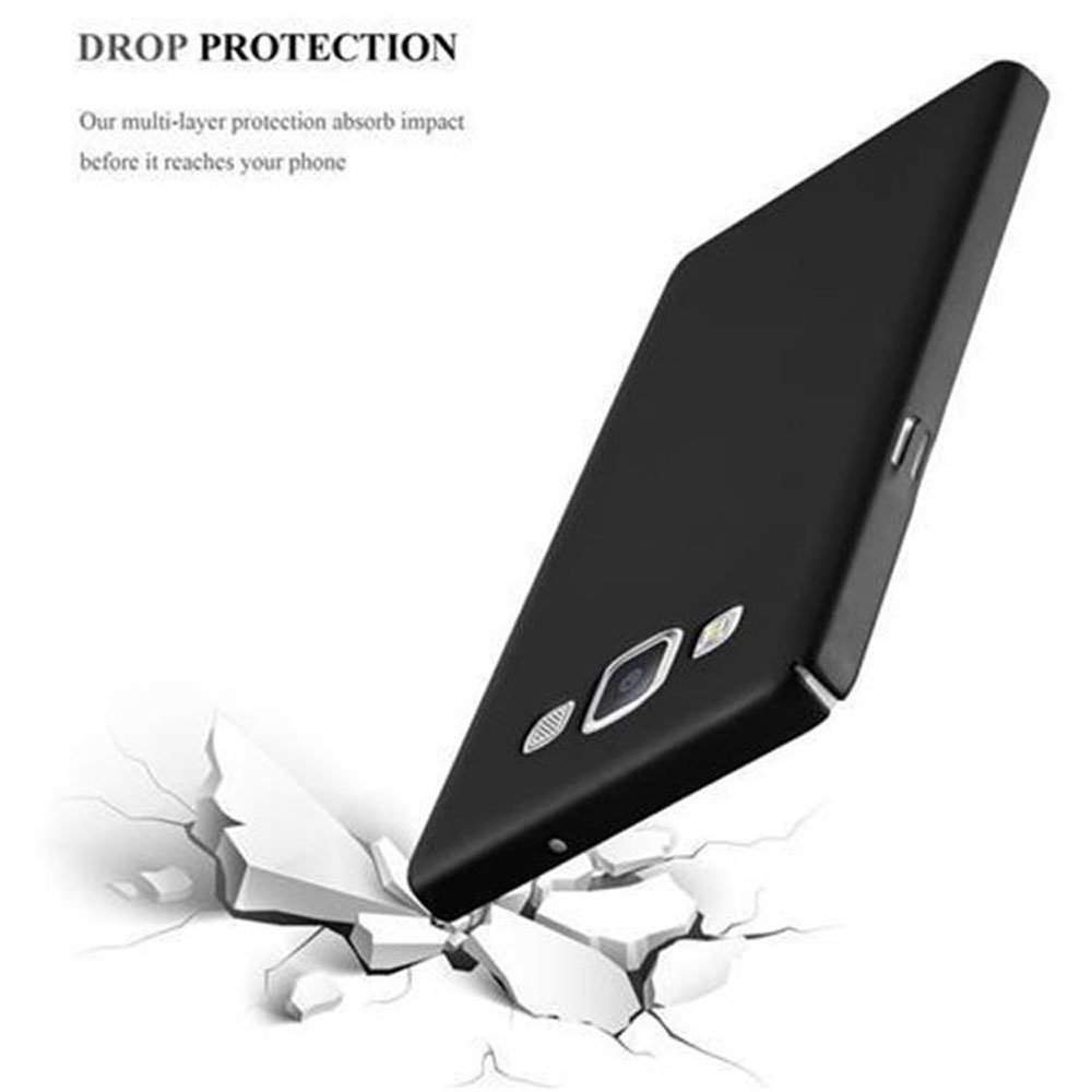 Teléfono negro con funda cae sobre pedazos rotos blancos.