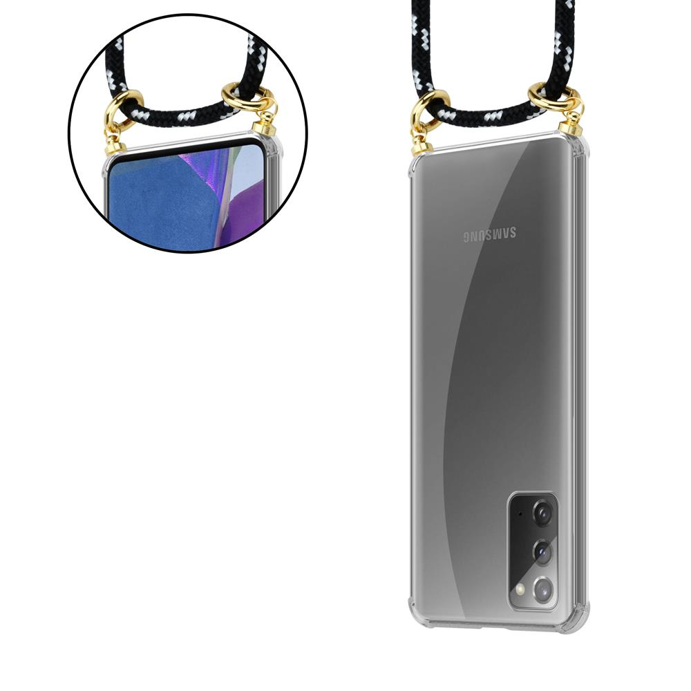 Custodia trasparente per telefono con cordino nero e accessori dorati.