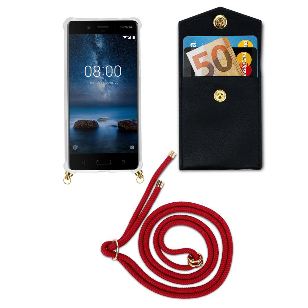 Ein Smartphone mit einer roten Schnur und einer schwarzen Brieftasche mit Geld und Karten.