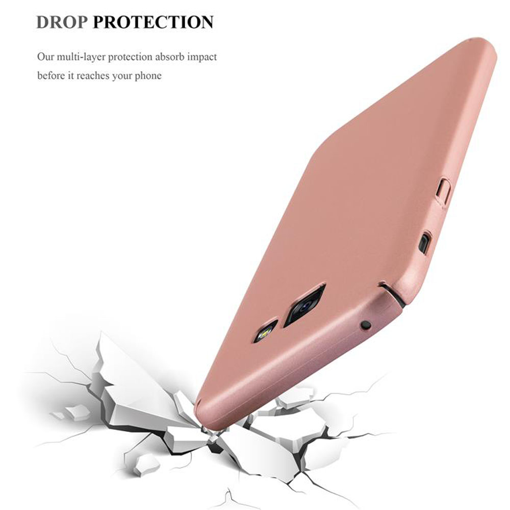 Una custodia per telefono rosa dorato che rompe una superficie bianca.