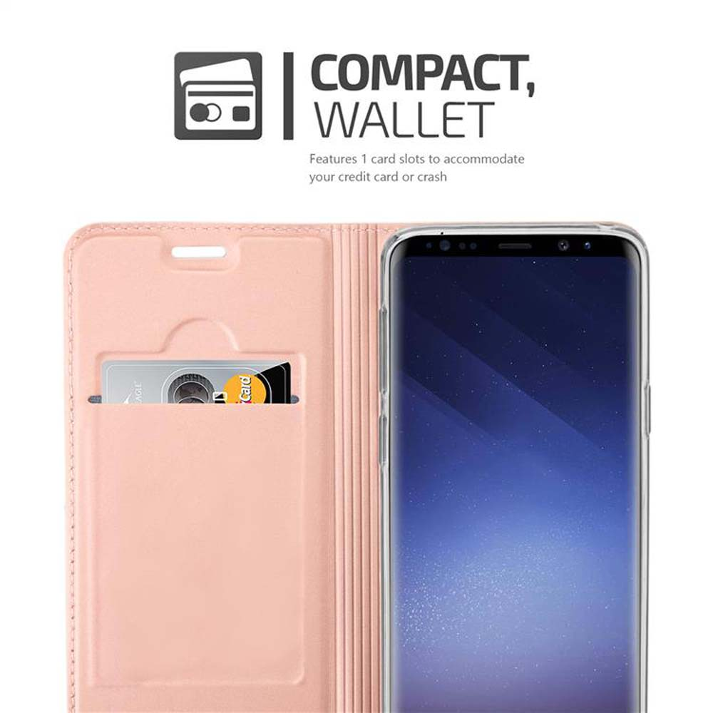 Un portafoglio rosa con uno scomparto per carte accanto a uno smartphone.