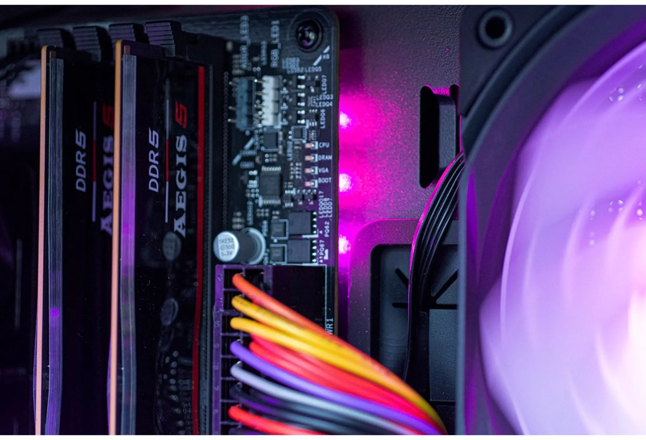 RAM sticks and motherboard components with purple LED lighting.